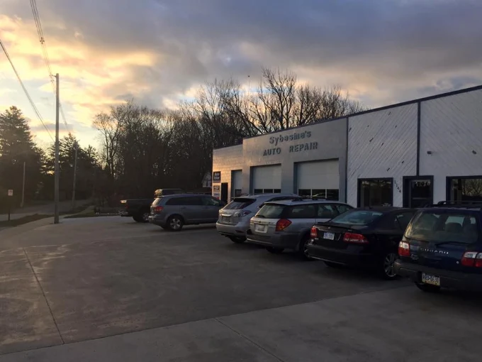 Vehicles outside Sybesma's Auto Repair at dusk